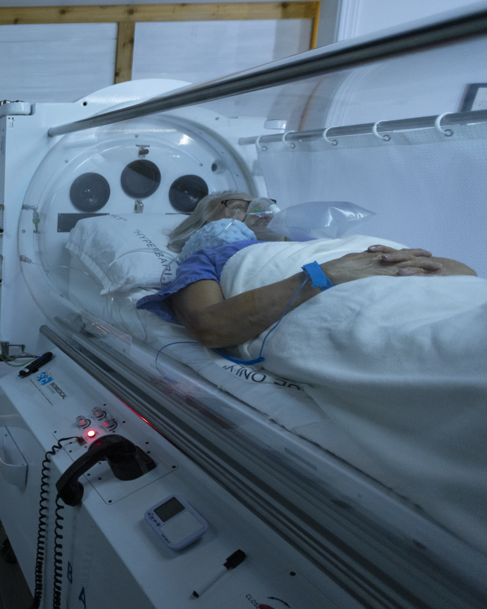 Young girl receiving oxygen in a hyperbaric oxygen chamber